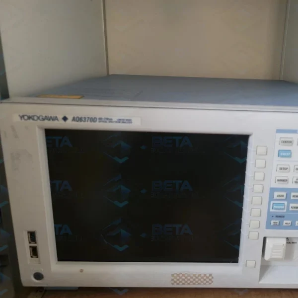 Front view of the Yokogawa ando AQ6370D Optical Spectrum Analyzer (600–1700 nm) resting on a surface. The light grey benchtop unit features a large central screen framed by softkey navigation buttons on the right. The top-left corner clearly displays the "YOKOGAWA AQ6370D" model branding above dual USB interface ports and the power button, while function menu buttons (CENTER, SWEEP, SETUP, MARKER) and the optical input port are located on the right control panel.